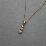 Graduated three diamond drop pendant in 14k gold